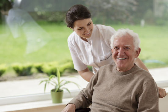 senior home care services with man beside caregiver