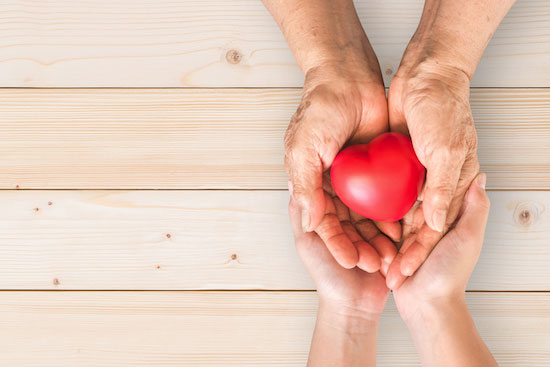 senior placement services hands holding heart
