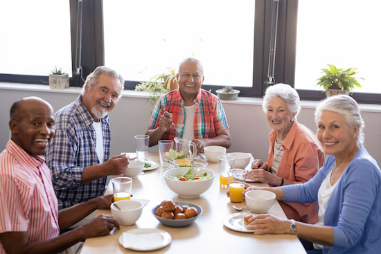 senior assisted living group at breakfast